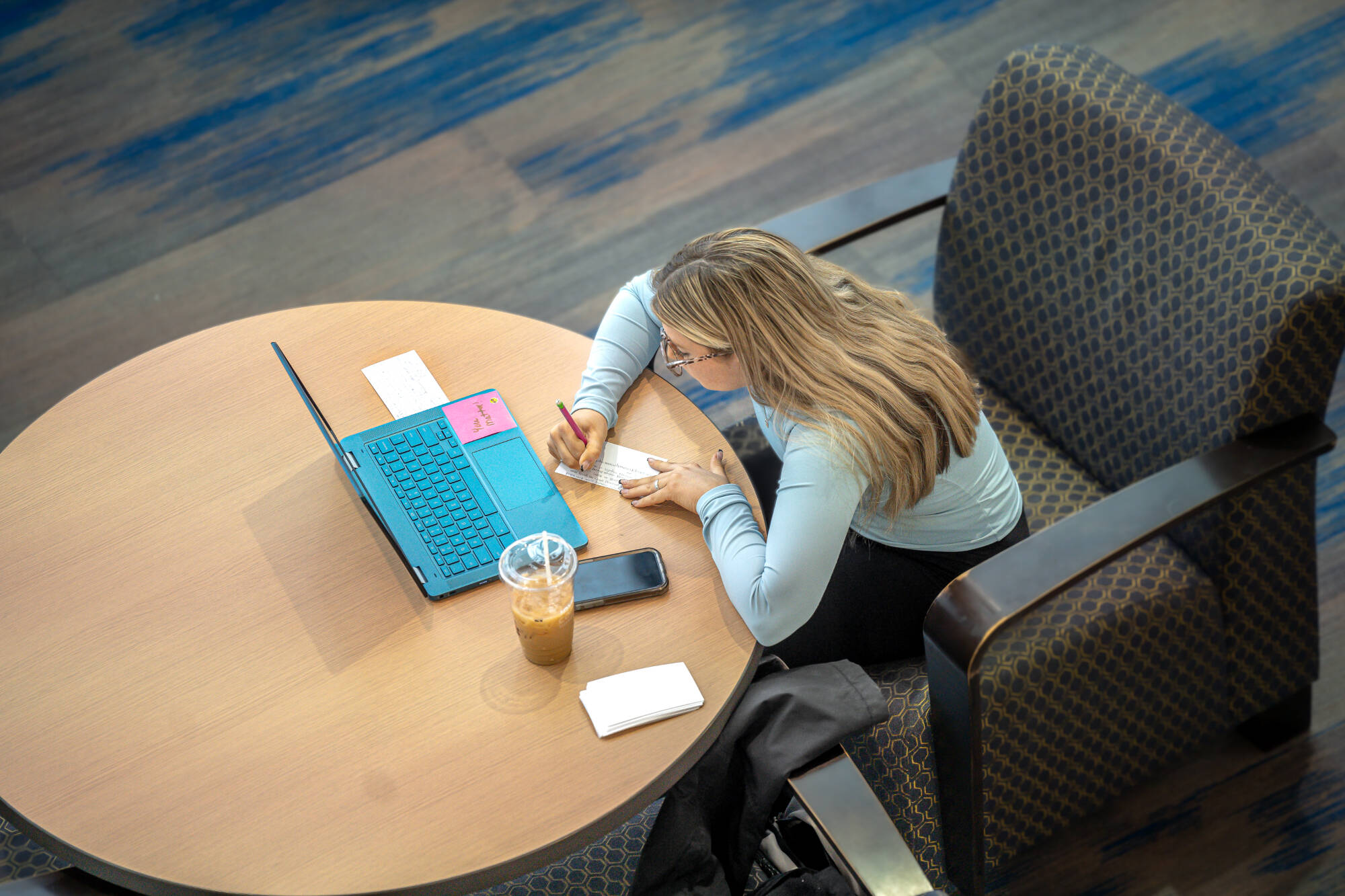 A student is diligently preparing for final exams, utilizing the Mary Idema Pew Library's resources and collaborative spaces to support their academic success on December 4th.
